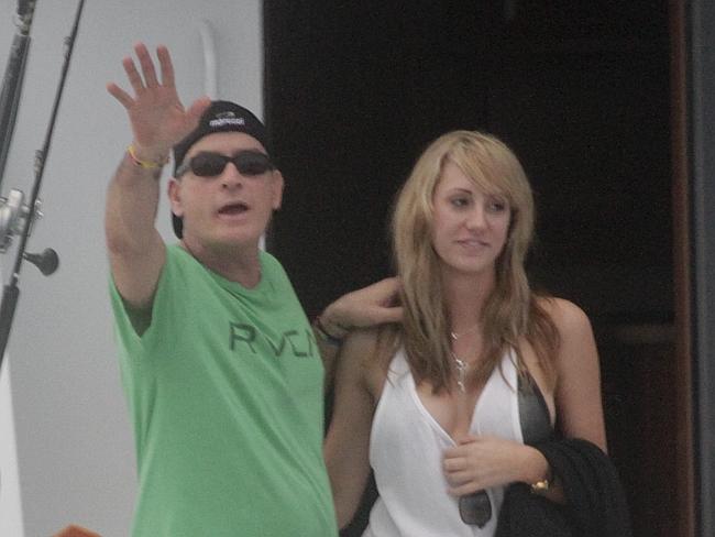 Damage ... Charlie Sheen, pictured here with his porn star fiance Brett Rossi, shares cus