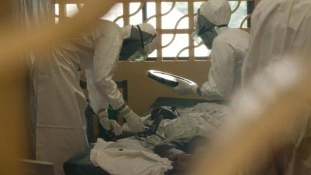 Dr Kent Brantly, left, at work with an Ebola patient in Monrovia, Liberia.