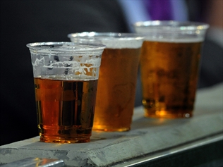 People drinking beer at a sporting venue