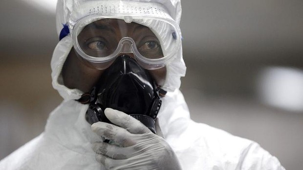 A Nigerian health official wearing a protective suit waits to screen passengers at the arrivals hall of Murtala Muhammed International Airport in Lagos, Nigeria.