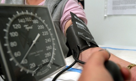 A patient has her blood pressure checked.