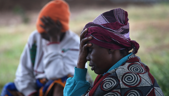 Above, patients wait outside of a new Ebola clinic being set up by the humanitarian group Doctors Without Borders.