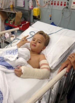 On the mend: Harry Bailey, now 8, was trampolining at a birthday party when he broke his arm.