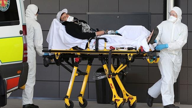 PARAMEDICS have suited up to rush a severely ill man to Gold Coast University Hospital this morning amid suspected Ebola virus fears.