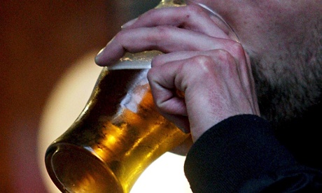 man drinking beer from glass