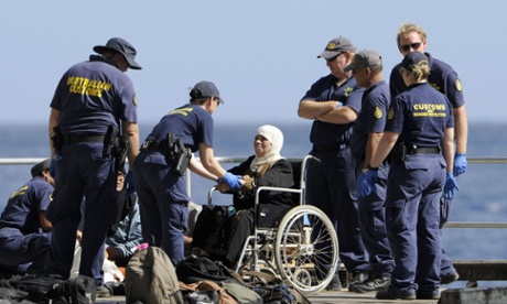 A woman is transferred to Christmas Island after being rescued from a boat in distress off Indonesia.