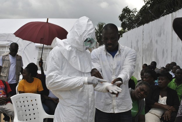 Health care workers in Sierra Leone practice putting on personal protective suits. A lack of basic medical equipment and infection control supplies has resulted in unprecedented viral transmission among health workers, WHO says. 