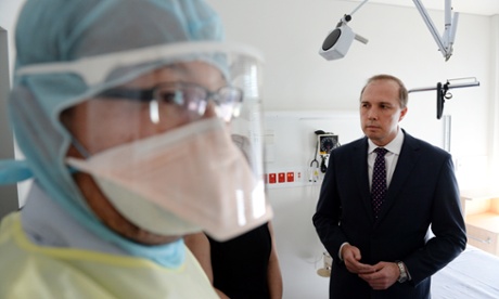 Peter Dutton with a nurse in protective gear during a visit to the Royal Brisbane hospital in Brisbane. 