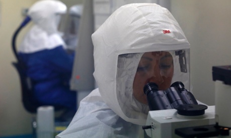 An unsuspecting doctor peers into a microscope of the kind that might one day be involved in some sort of Ebola doomsday scenario yesterday.