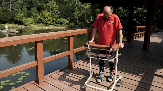 Bulgarian man Darek Fidyka walks with the aid of leg-braces and a walking frame at the Ak