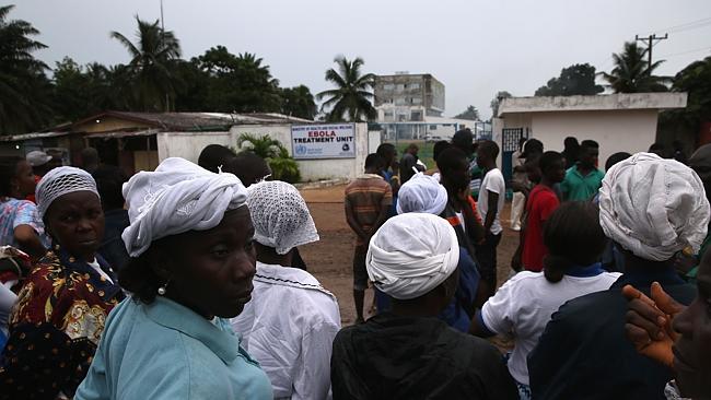 Fear factor ... people gather outside the Island Clinic Ebola treatment centre in Monrovi