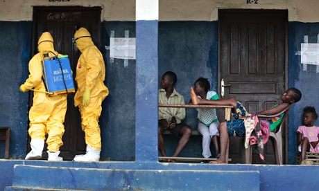 Health workers disinfect a home