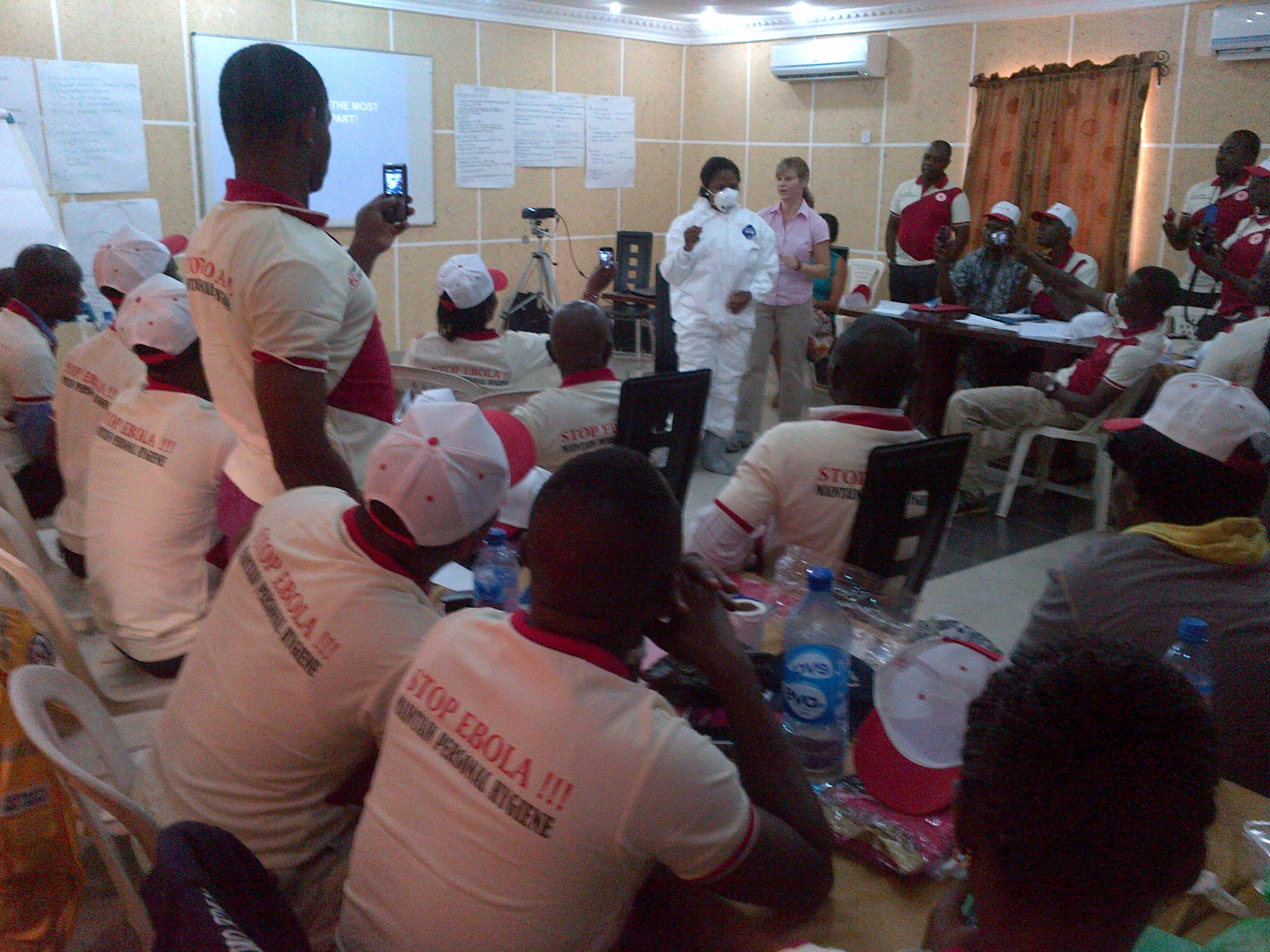 Local volunteers working with CDC staffers gather for a meeting on Ebola preparedness in Lagos, NIgeria.