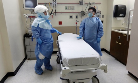 Bellevue Hospital nurse Belkys Fortune, left, and Teressa Celia, Associate Director of Infection Prevention and Control, in protective suits in an isolation room.