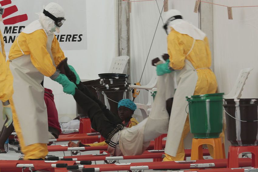 Independent humanitarian medical group Medecins Sans Frontieres (MSF) personnel carry a man suspected of having the deadly Ebola Virus inside MSF's Ebola isolation and treatment center in Monrovia, Liberia, on Sept. 29, 2014.