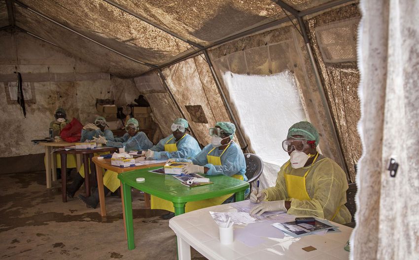 A health worker wearing protective clothing and equipment, await patients to screen against the deadly Ebola virus at the Kenema Government Hospital situated in the capital city of Freetown, Sierra Leone on August 9, 2014.