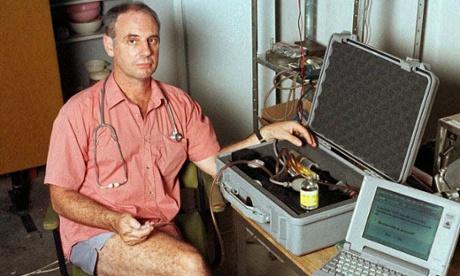 Dr Philip Nitschke in his office in June 1996 with his euthanasia delivery system, which comprised a lap-top computer and a box containing a syringe which was connected to the patient by intravenous line and driven by compressed air. The equipment was labelled 'The Death Machine'. Dr Nitschke assisted in the second legal suicide in Darwin on 2 January 1997, of Janet Mills, 52, who suffered from terminal skin cancer.