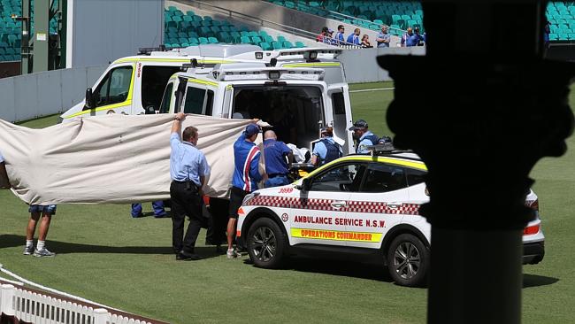 Phillip Hughes is loaded into the back of an ambulance.