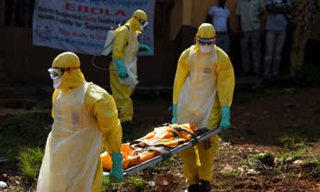 Health workers from Sierra Leone's Red Cross Society Burial Team 7 carry a corpse in Freetown.