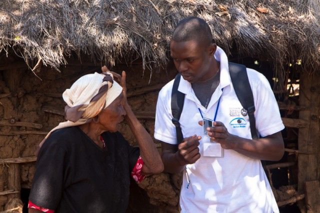 Vision testing outside a blind patient's home.