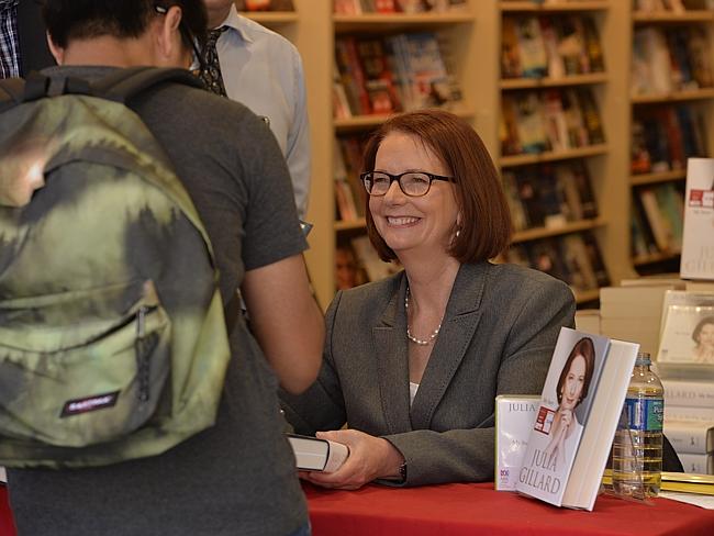 Former prime minister Julia Gillard signs copies of her autobiography at Dymocks. Picture