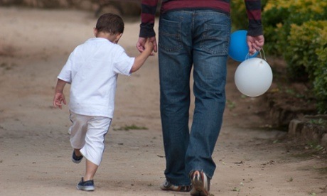 Boy holding father's hand