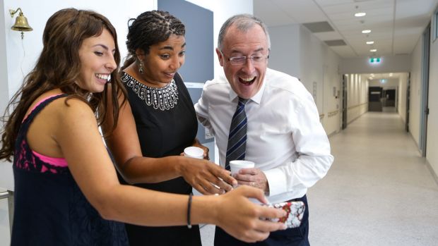 Jaida, Dr Antoinette Anazodo and Professor William Ledger watch a video of the song that was performed by medical staff and friends after Jaida's final cancer treatment.