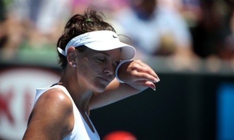 Casey Dellacqua wipes sweat from her forehead during the 2014 Australian Open as temperatures reached over 40C. 