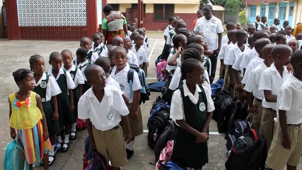 Students stand in line at Don Bosco High School, in the Monrovia.