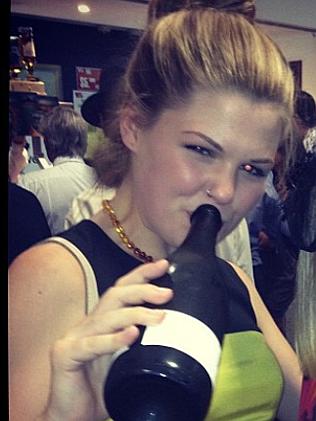 A social media image of Belle Gibson drinking from a champayne bottle.