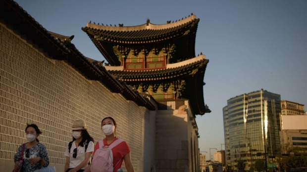 People wearing face masks outside the Gyeongbokgung palace in Seoul on Wednesday.