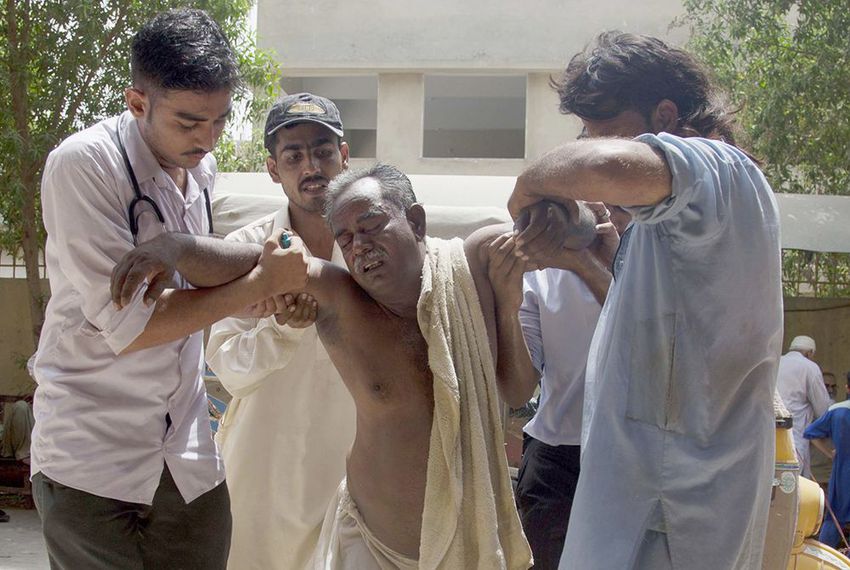 People rush a patient to a hospital suffering from heatstroke in Karachi, Pakistan on June 23, 2015.