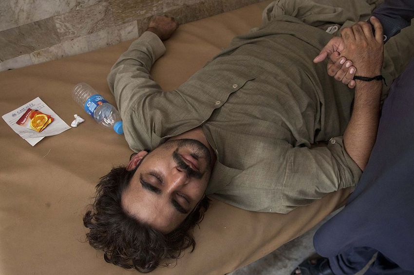 A Pakistani patient suffering from heatstroke waits for medical help at a local hospital in Karachi, Pakistan on June 23, 2015.