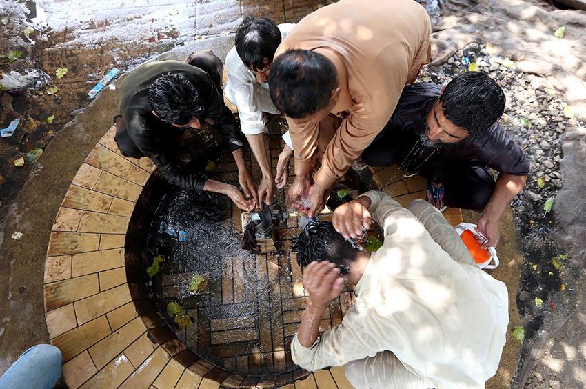 Pakistani people cool off on a hot day in Karachi, Pakistan.