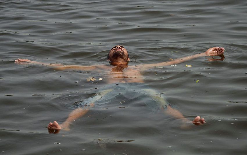 A Pakistani youth cools off in the sea during a heatwave in Karachi on June 22, 2015.