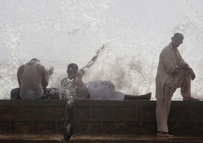 People cool themselves off at Karachi's shore in Pakistan.