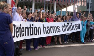 Doctors and healthcare workers at the Royal Children’s hospital in Melbourne on 12 October protest against children being held in detention.