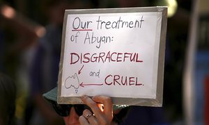 A protester supports refugees during a rally in Sydney.