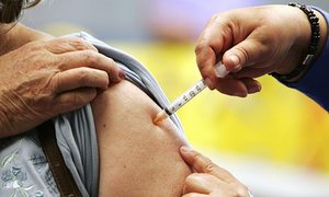 A woman receiving a flu vaccination. Health minister Sussan Ley says the higher number of cases could be because more people were visiting a doctor for a diagnosis.