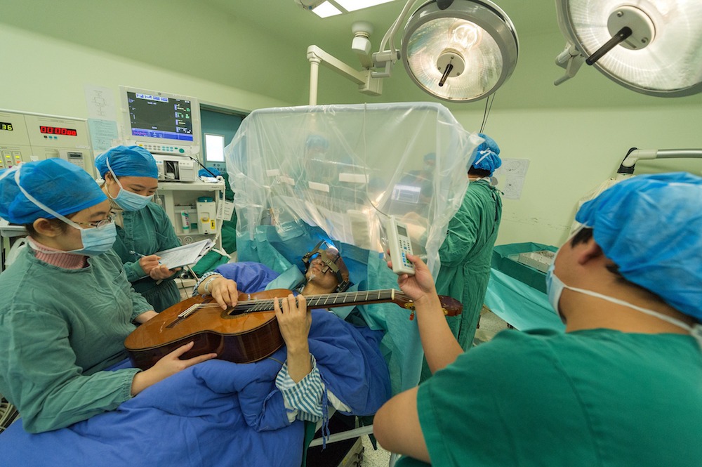 Man plays guitar while having brain surgery