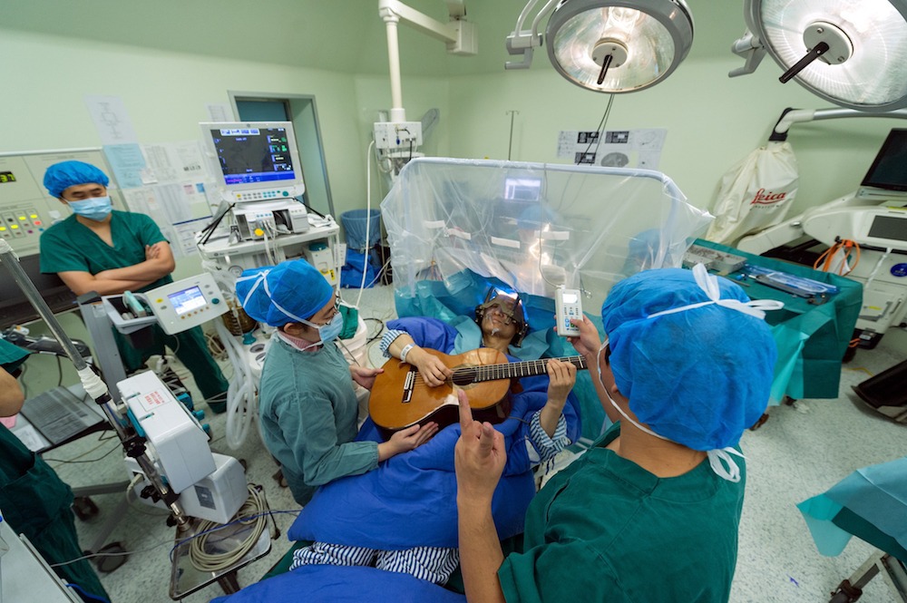 Man plays guitar while having brain surgery