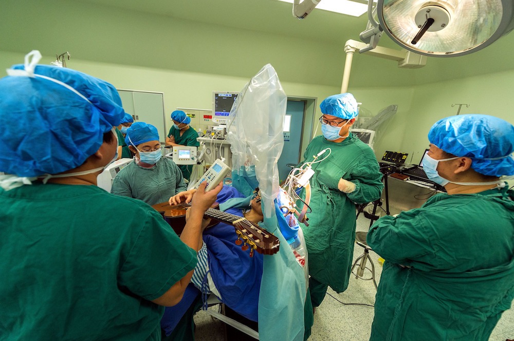 Man plays guitar while having brain surgery