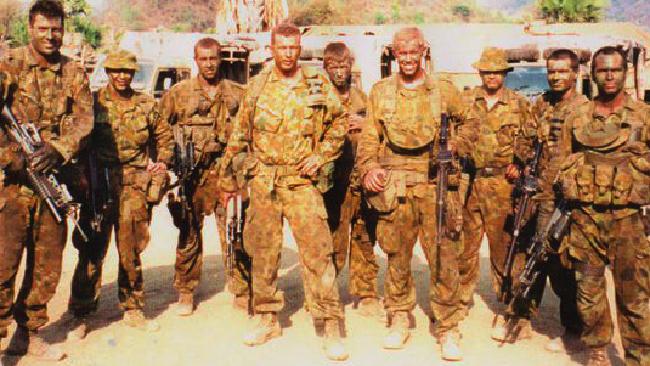 Discharged ... Former soldier Paul Golle (centre) and comrades in East Timor in 2001. Picture: supplied.